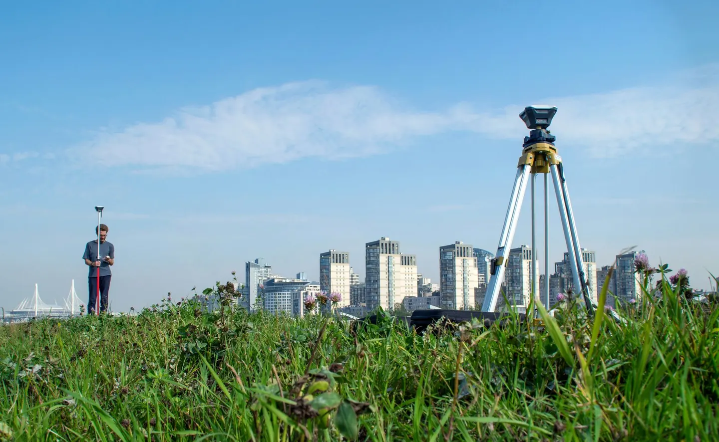 Survey equipment and a GNSS rover in an outdoor urban setting