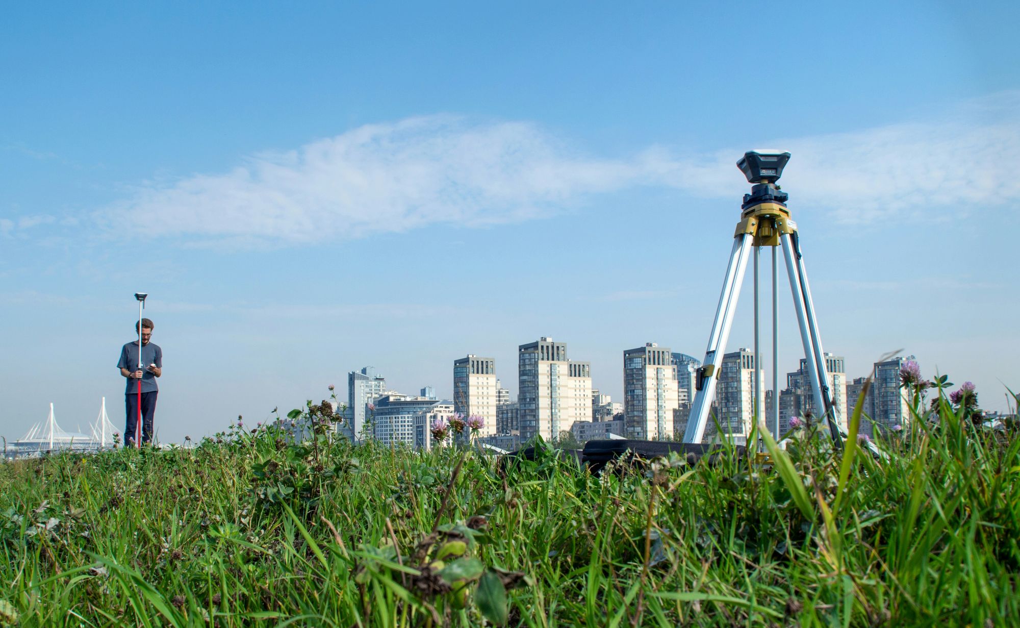 Survey equipment and a GNSS rover in an outdoor urban setting